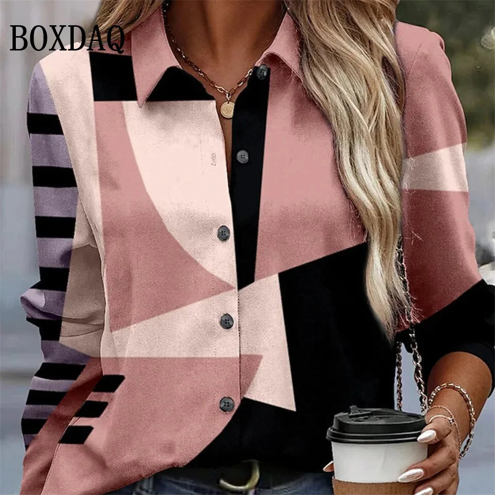 A woman wearing a geometric print button-up shirt with pink, black, and light beige sections, holding a coffee cup. The brand name BOXDAQ is visible in the top left corner.
