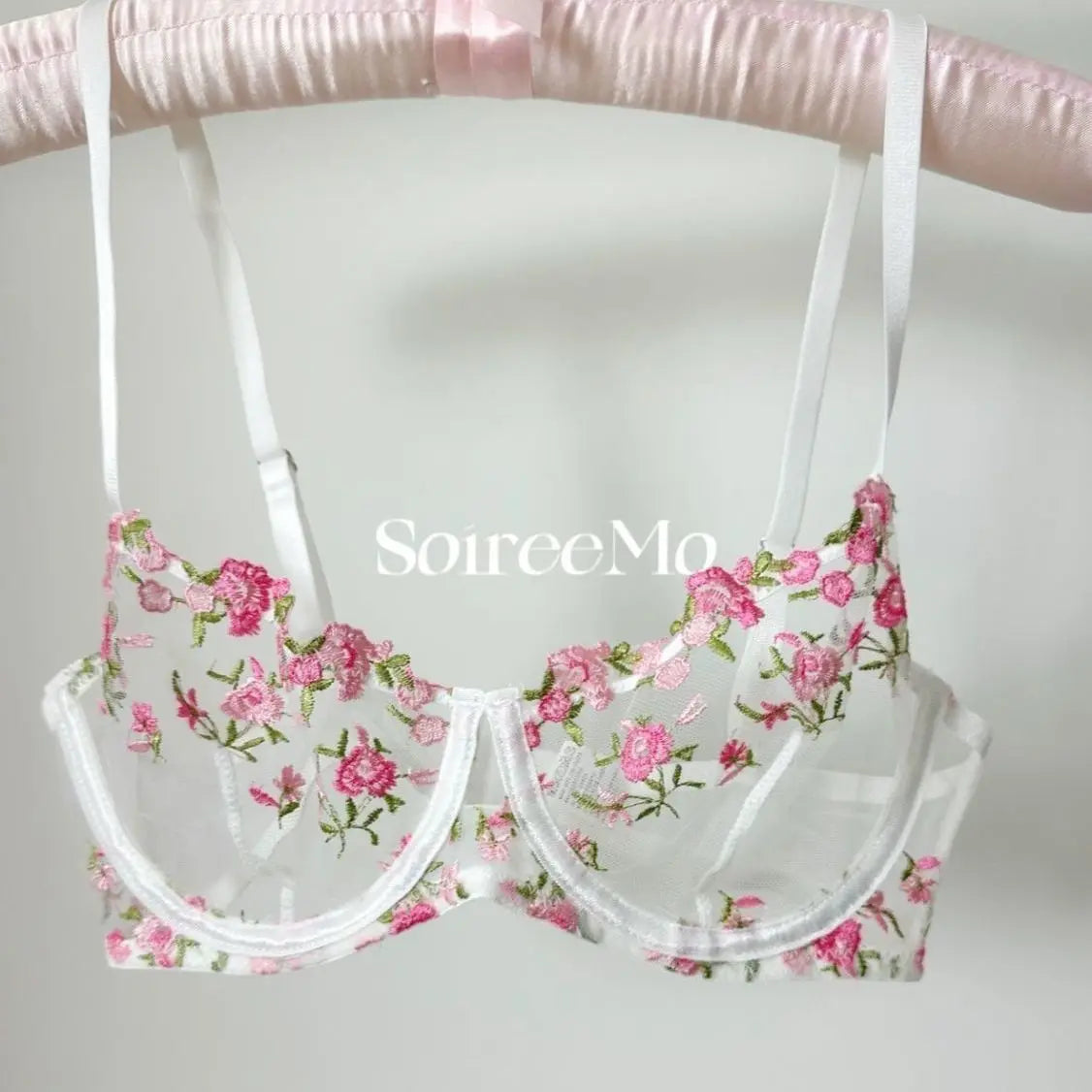 Floral-patterned bra and panties set on a white background with 'SourceMo' branding.