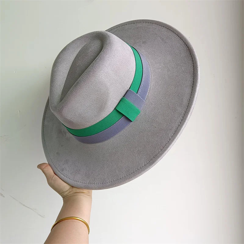 Gray fedora hat with a green and purple band held by a hand on a white background