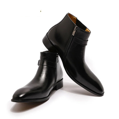 Pair of black leather boots with a buckle on a white background