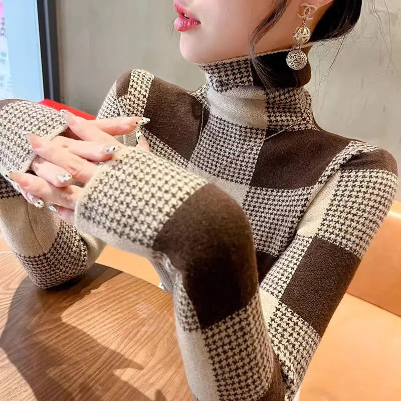 Person wearing a checkered outfit with brown and white pattern, sitting indoors.