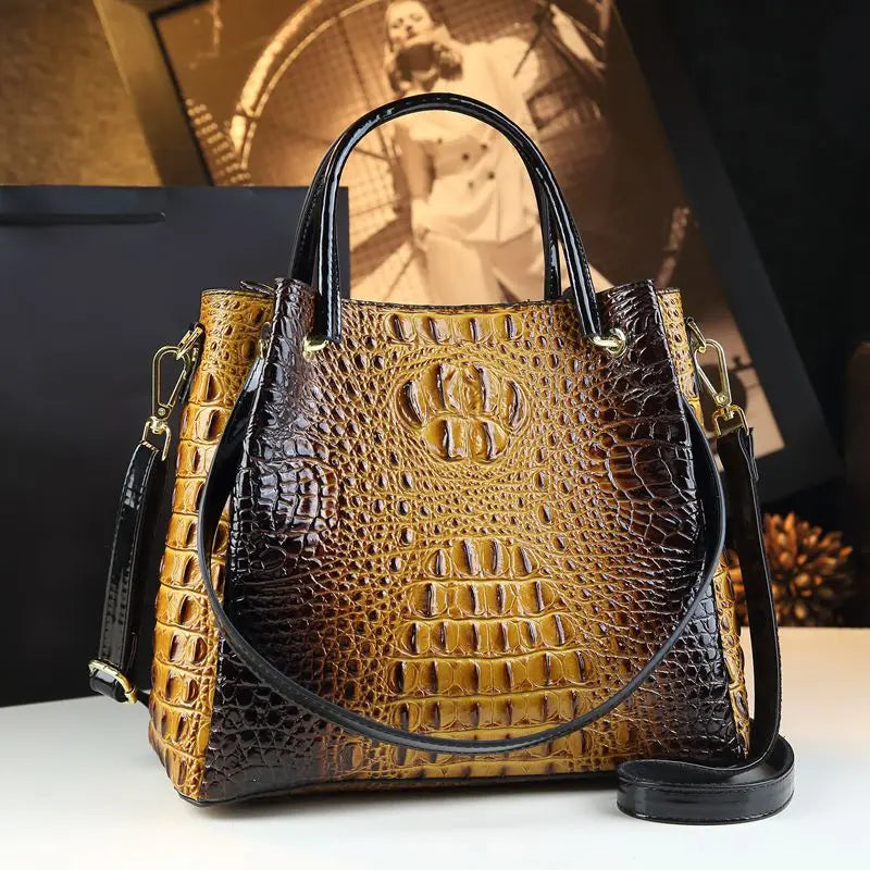 Brown crocodile-patterned handbag with gold accents on a white surface. Vintage genuine leather bucket tote bag with crocodile print. Soft medium-hardness leather, zipper closure, interior pockets. Stylish crossbody bag UK.