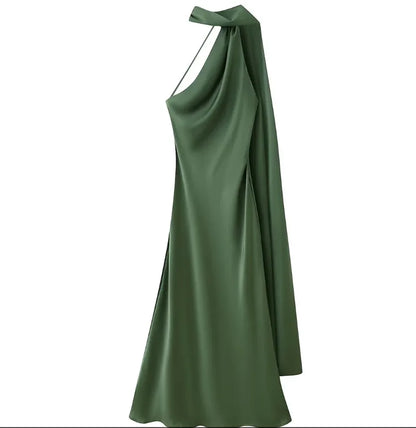 A dark green satin halter dress with a draped, asymmetrical neckline and a flowing silhouette, shown against a plain white background.