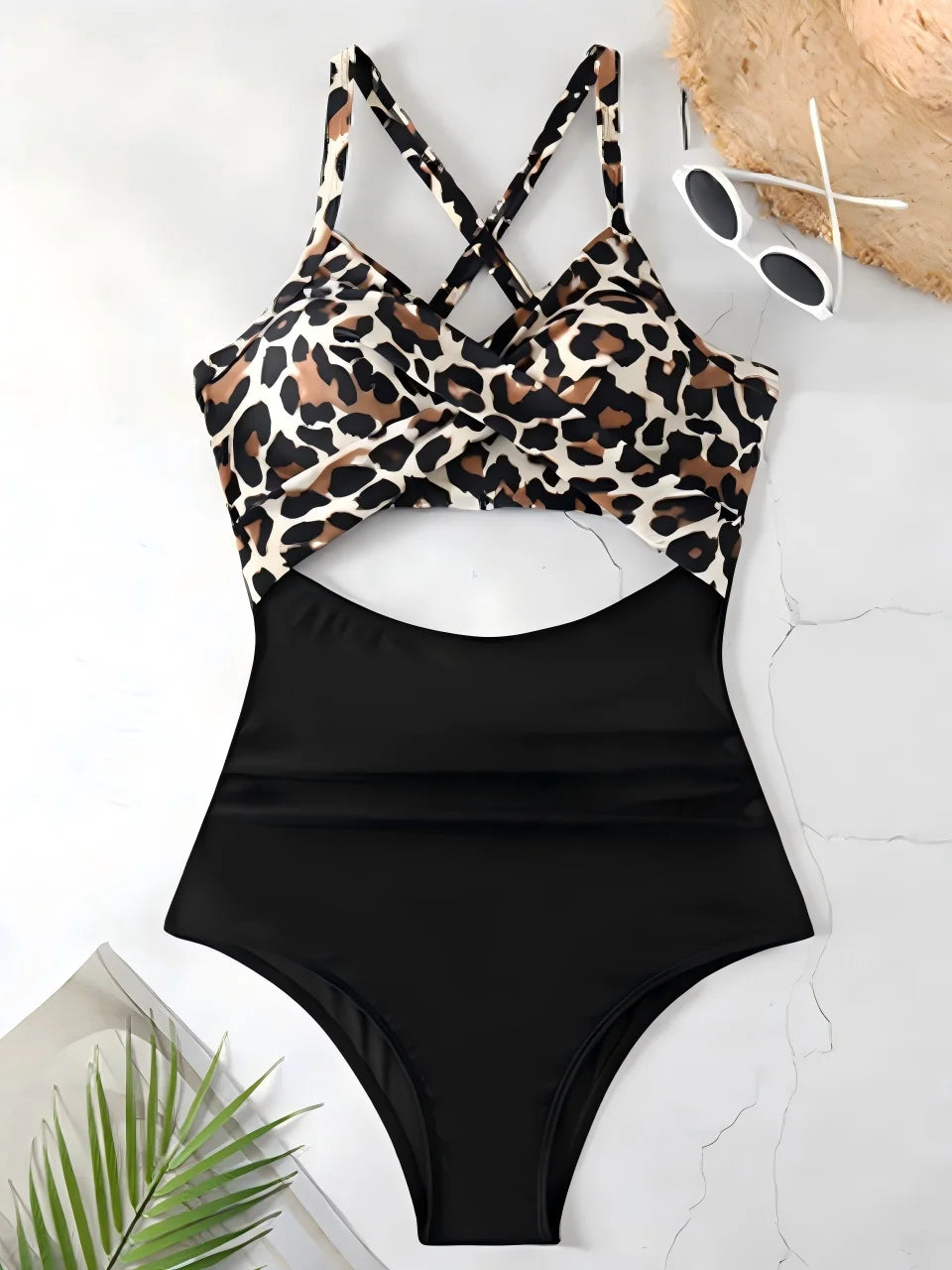 Black swimsuit with leopard print top on a white surface