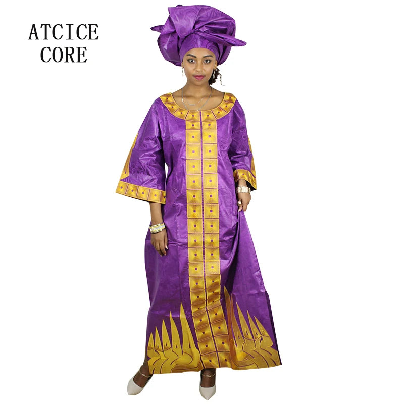 Woman wearing a purple and gold traditional outfit with a matching headwrap on a white background.