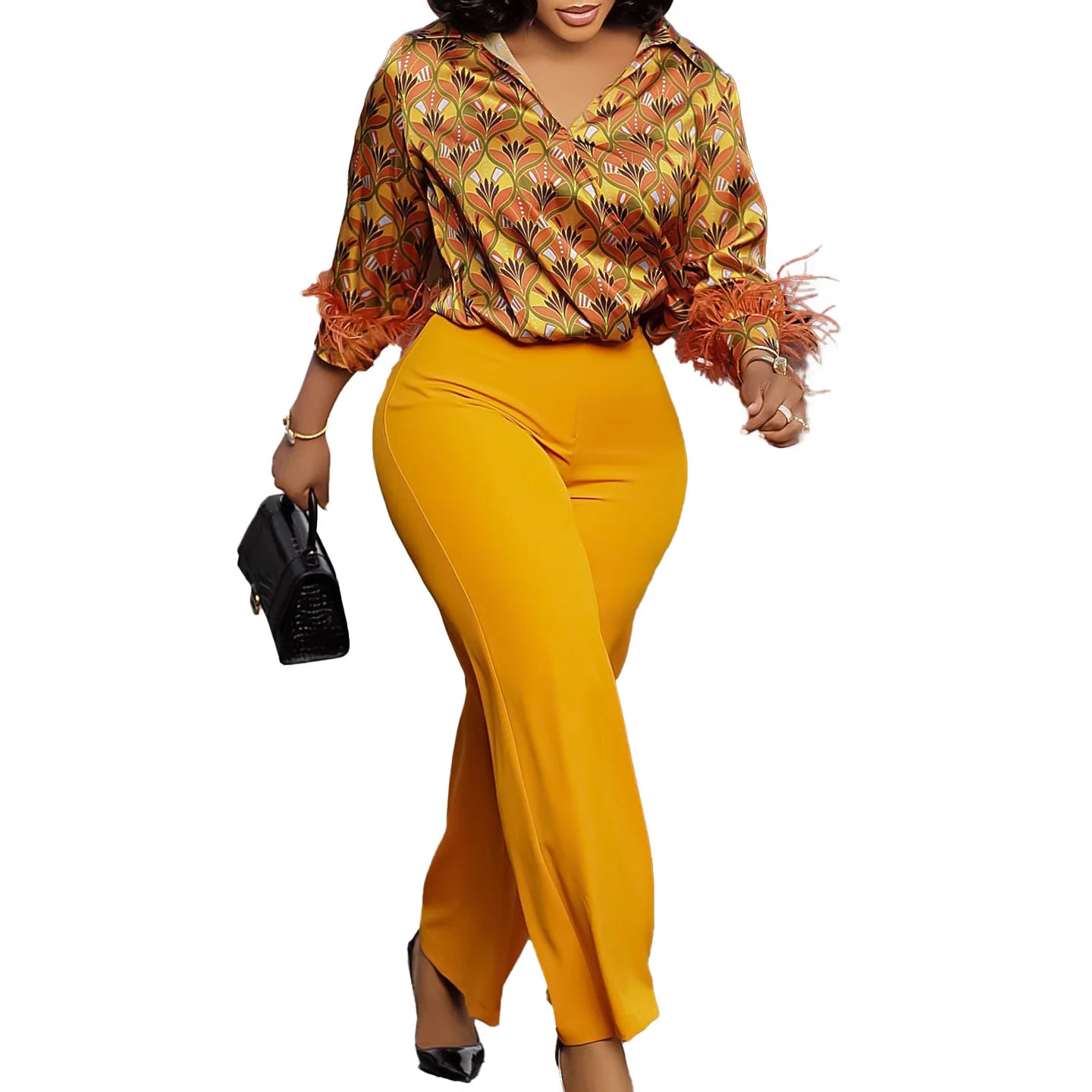 Woman wearing a patterned blouse and yellow pants on a white background. African print two-piece polyester outfit with satin printed shirt and high waist wide leg pants. Comfortable, elegant office wear for women.