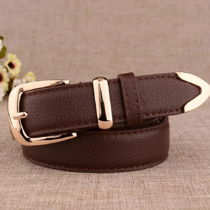 Brown leather belt with gold buckle on a textured surface. Women’s vintage white leather trouser belt with solid pin buckle. Stylish, high-quality accessory for fashion-forward looks, UK.