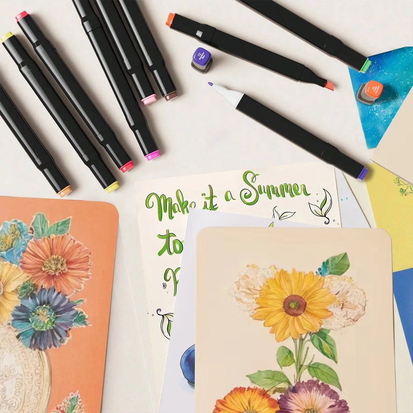 Colorful markers and notebooks with floral designs on a white background. Pro Dual-Tip Alcohol Markers Set featuring fine and chisel tips, vibrant streak-free ink, ergonomic design for artists’ coloring and sketching projects UK.