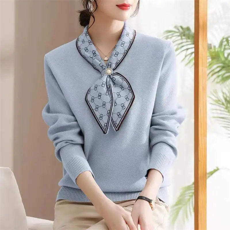 Light blue sweater with decorative collar worn by a person indoors.