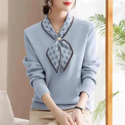 Light blue sweater with decorative collar worn by a person indoors.