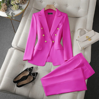 Pink suit with gold buttons on a white chair, accompanied by black shoes and a white handbag.