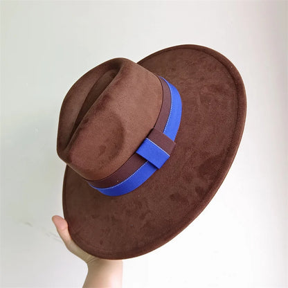 Brown fedora hat with a blue band held against a white background