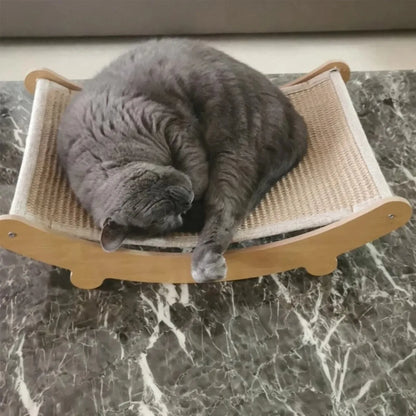 Gray cat sleeping on a wooden and fabric cat bed on a marble surface. Wooden cat scratching pad & bed, single layer, sisal surface, pet furniture, kitten recliner, multi-purpose cat toy for lounging and claw care.