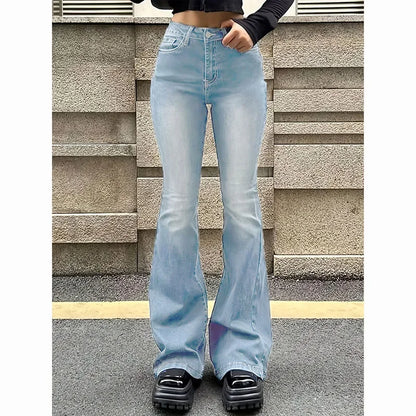 Person wearing light blue flared jeans standing against a stone wall. Women’s high waist flared jeans, stretchy bootcut denim trousers. Thin fabric, solid color, bell bottoms style for casual chic UK fashion.