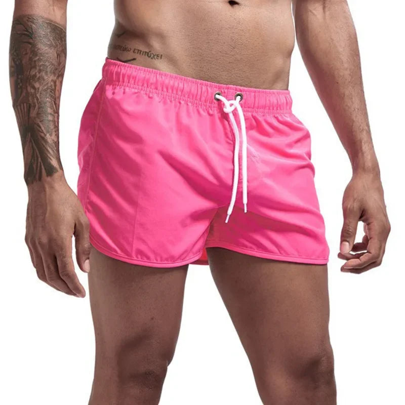 Men's pink quick-drying swimming trunks in vibrant colors for beach and surfing