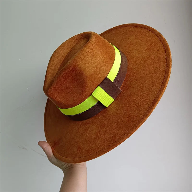Brown hat with a yellow and brown band held against a gray background