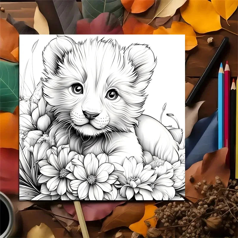 Coloring book page with a lion cub and flowers surrounded by autumn leaves and coloring supplies. Animal Paradise adult coloring book featuring therapeutic art, cute cats, floral designs for relaxation, FTF Market UK.