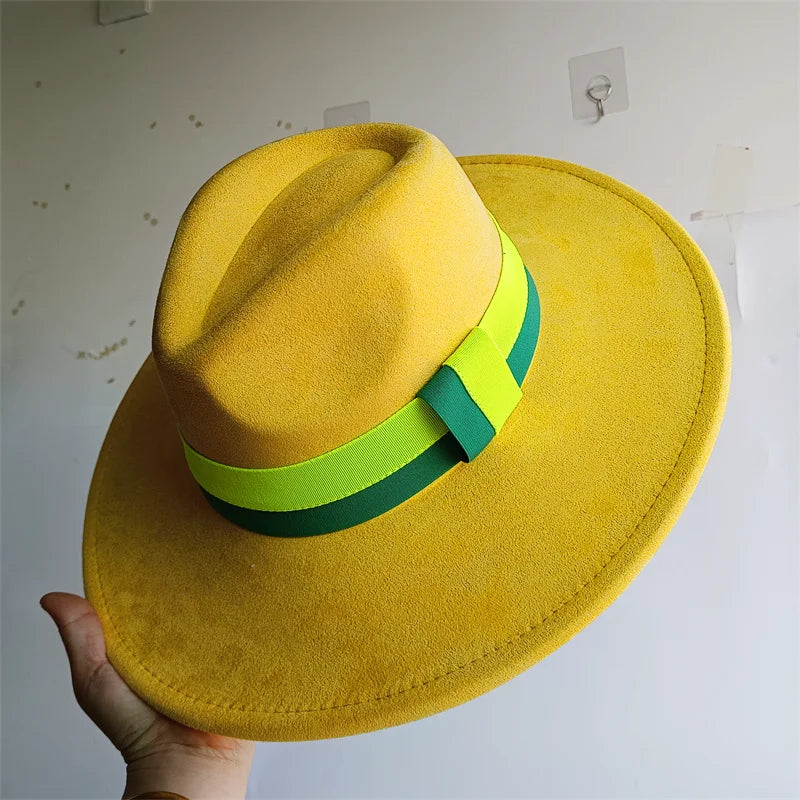 Yellow hat with green and lime green band held against a plain background