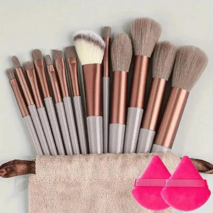 Set of makeup brushes with a carrying case and pink applicators on a light background. Soft fluffy makeup brush set with wool fiber bristles and plastic handles. Complete set for powder, foundation, eyeshadow, and beauty blending.