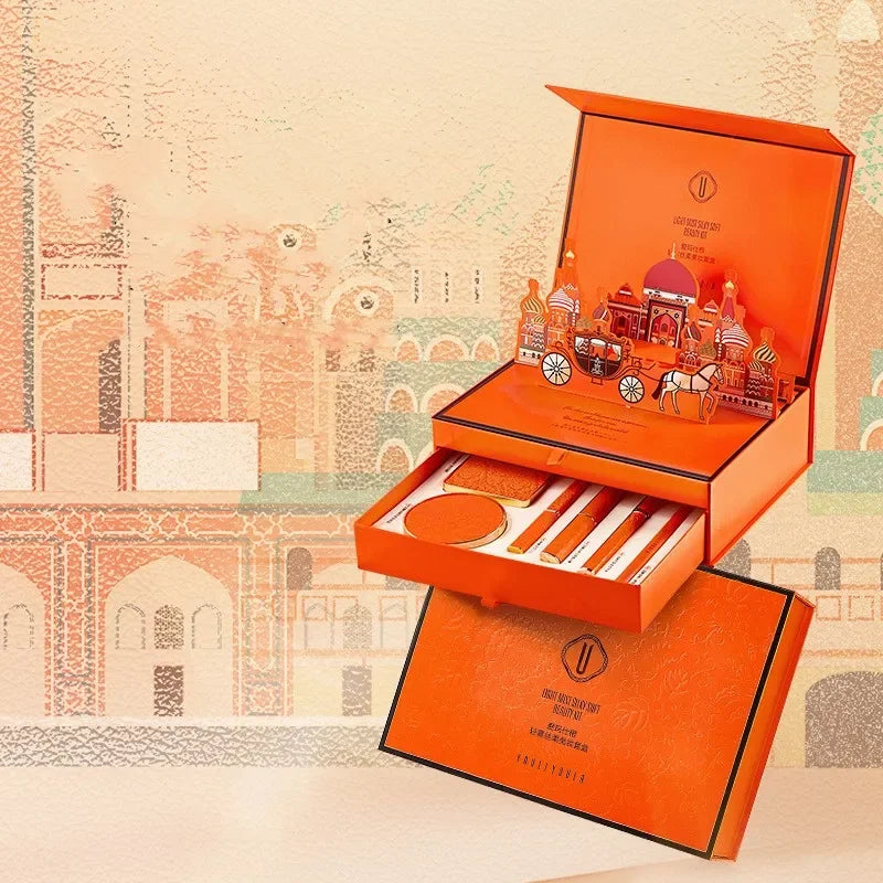 Orange cosmetic set with accessories on a decorative background. Christmas makeup gift box with BB cream, lipstick, eyeshadow, eyebrow pencil, and brushes. Holiday beauty set for women & girls.