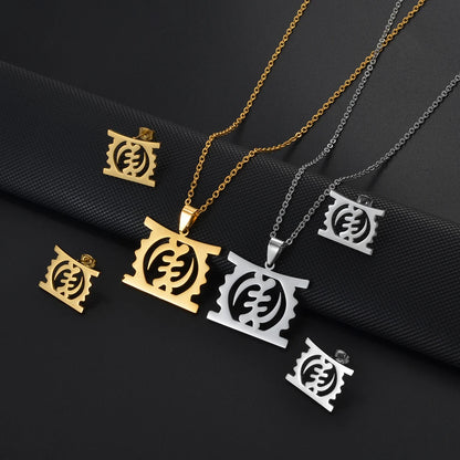 African Gye Stool pendant necklace and stud earrings set in gold and silver on dark background