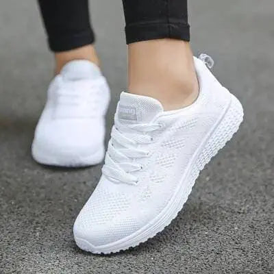 Women's white breathable mesh sneakers with lace-up closure and lightweight sole