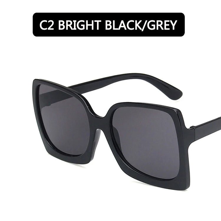 Black sunglasses with dark lenses on a white background. Big frame oversized rectangle sunglasses with gradient UV400 mirrored lenses UK.