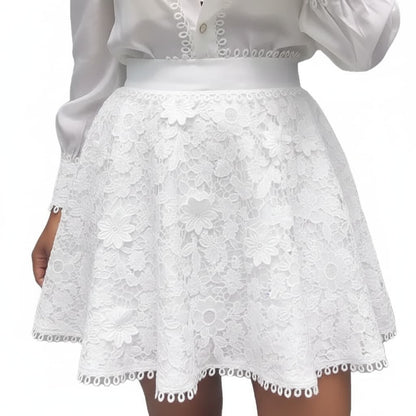White floral lace mini skirt with a matching white waistband, shown on a model wearing a white blouse against a plain white background.