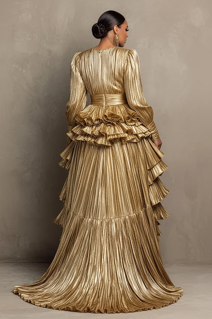 A woman shown from the back wearing a floor-length metallic gold gown with pleated texture, long sleeves, a ruffled waist, and a long train against a neutral studio backdrop.