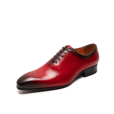 Red leather dress shoe on a white background