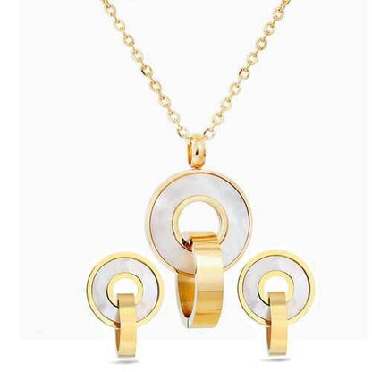 Gold and white circular jewelry set with necklace, earrings, and ring on a white background