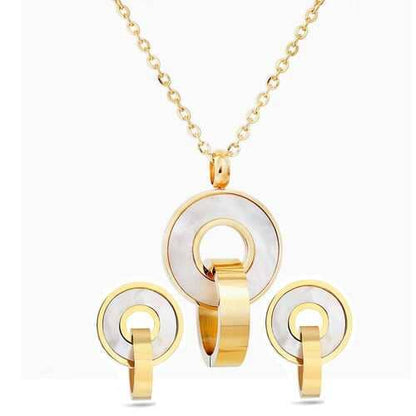 Gold and white circular jewelry set on a white background