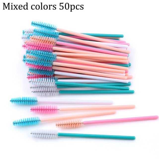 A collection of disposable eyelash brushes in various colors including black, pink, purple, blue, and white, with plastic handles.